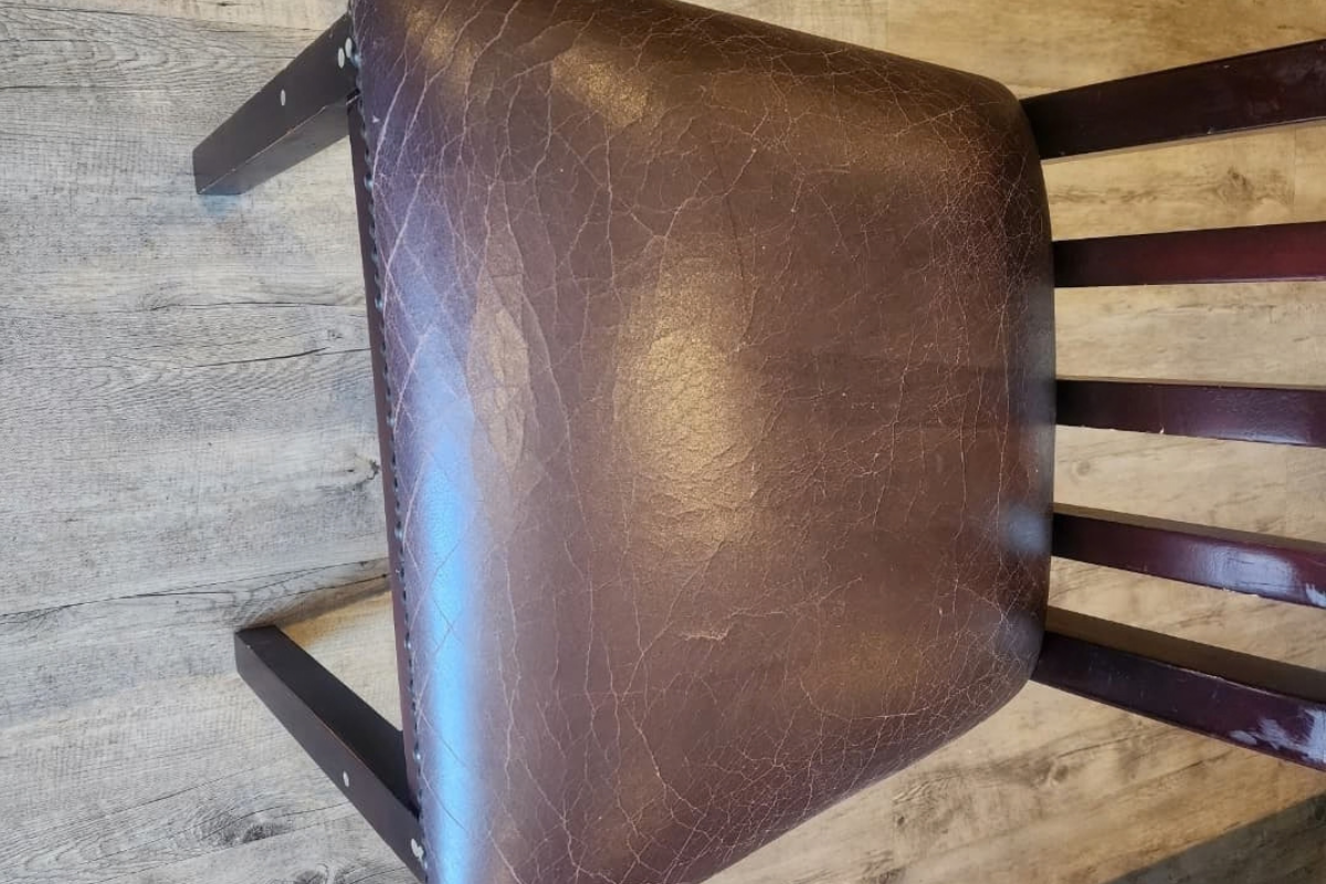 Leather dining chair before upholstery cleaning Brackenfell